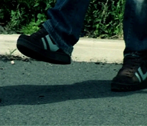 An image of a man standing on one foot while balancing on the other