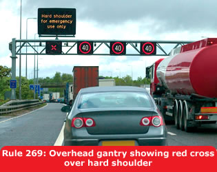 Overhead gantry showing red cross over hard shoulder