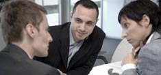 FAQs photo of three people talking at a table